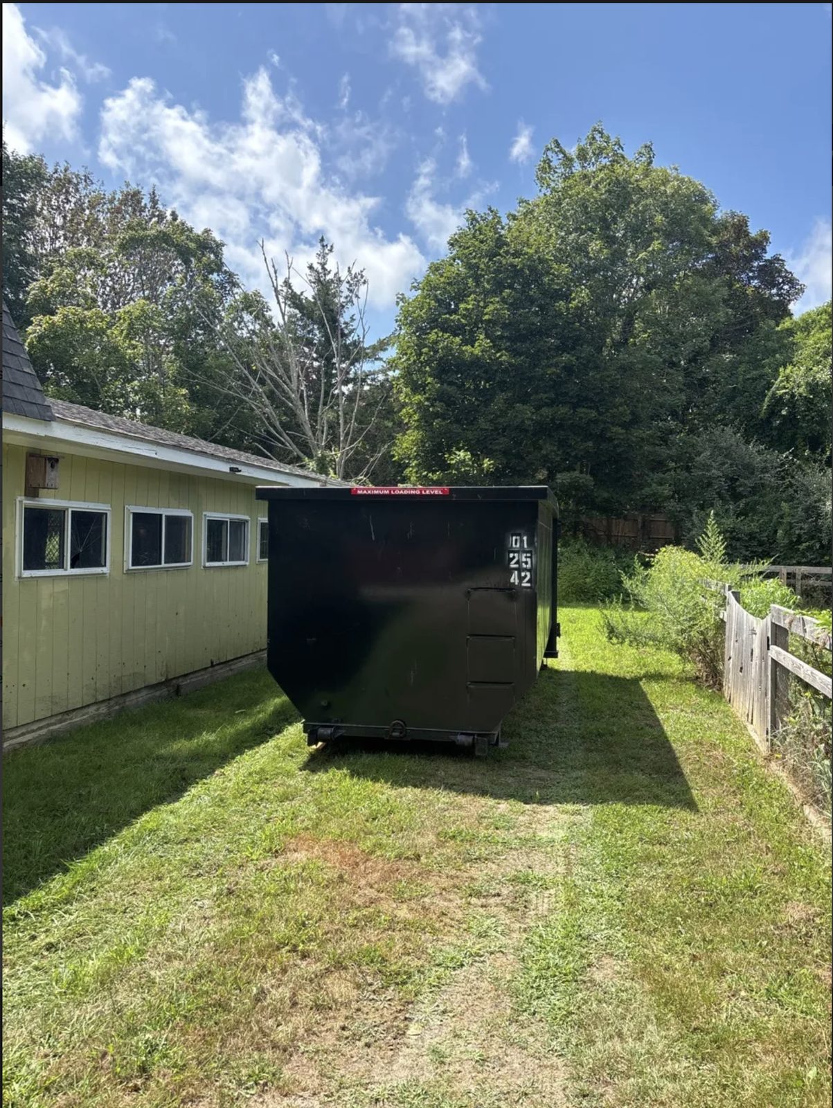 Dumpster rental on a lawn in Barnstable, MA