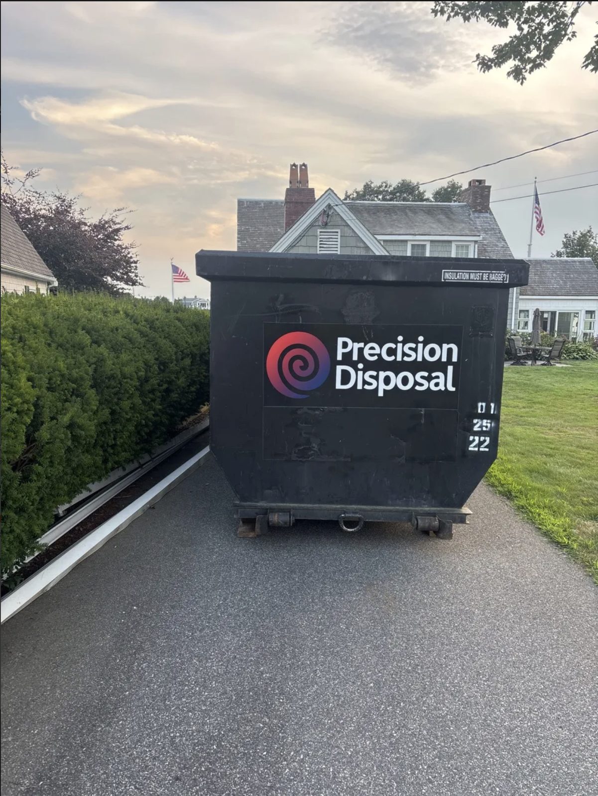 Precision Disposal dumpster in a residential driveway