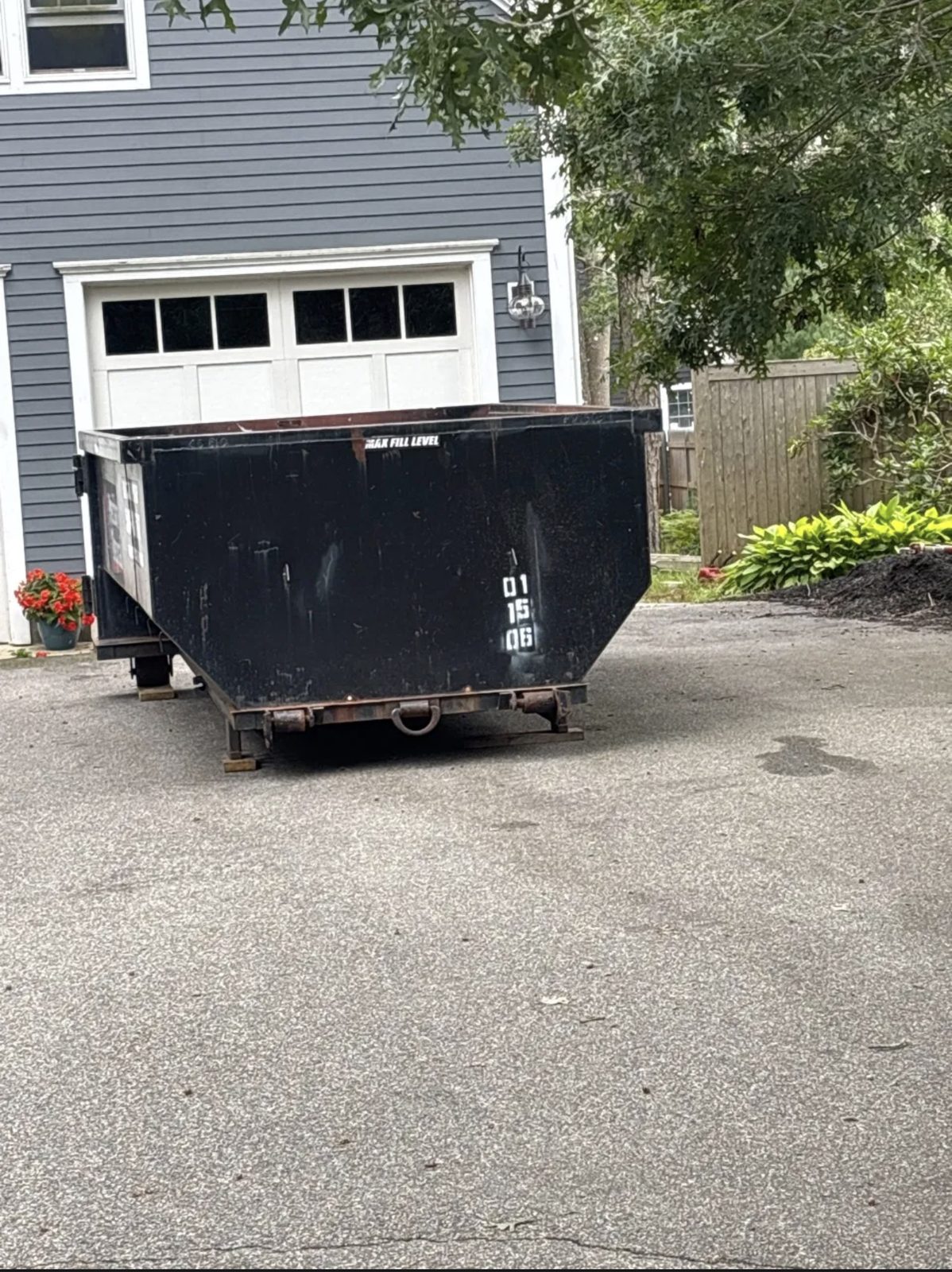 Roll-off dumpster in a Mashpee, MA driveway