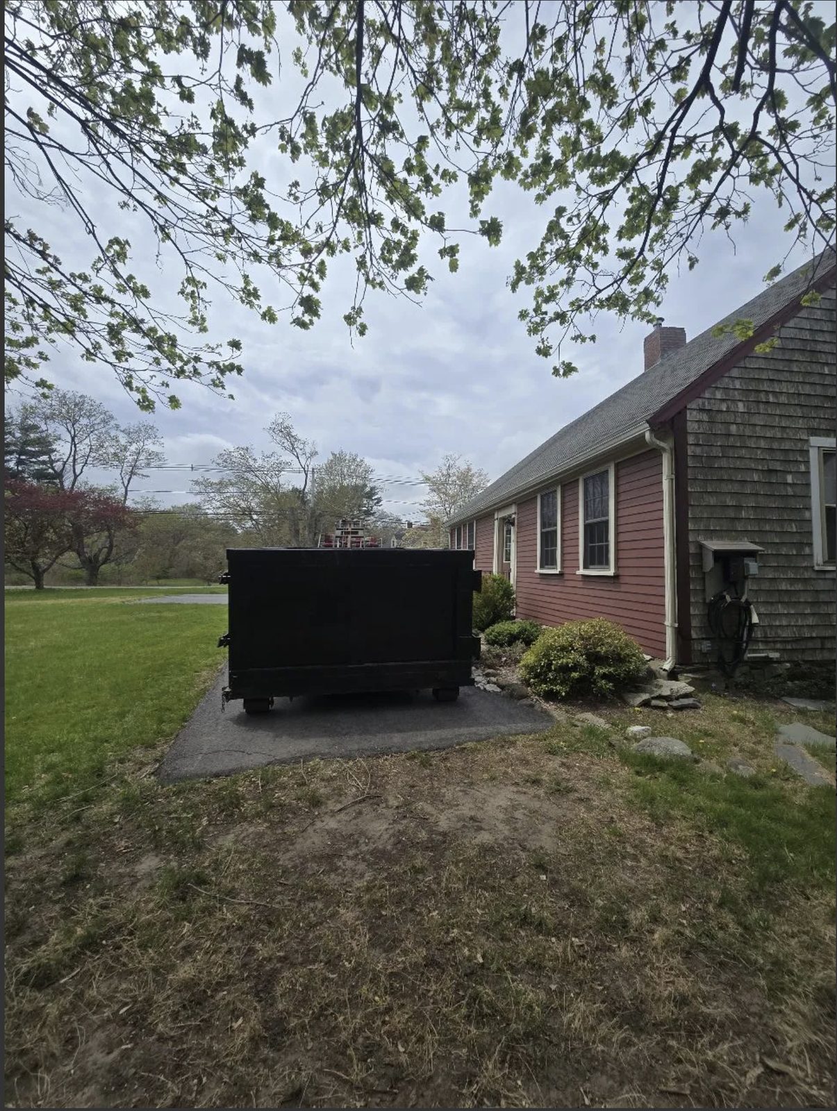 Roll-off dumpster delivered to a home driveway in Middleborough, MA